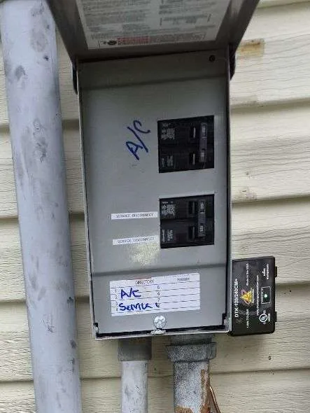 New outside breaker panel with AC breaker and disconnect breaker on a Largo, FL home, installed by Keywest Lights & Electric