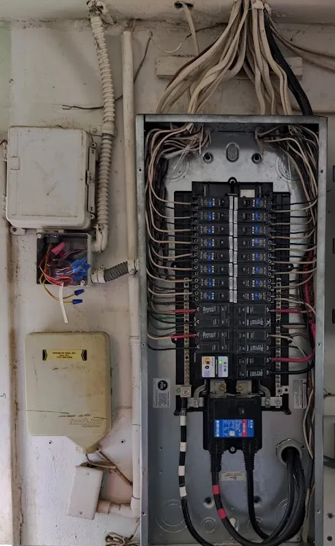 Electrical Panel Upgrades in Indian Rocks Beach, FL Breaker panel with a new Eaton main breaker on a utility room wall