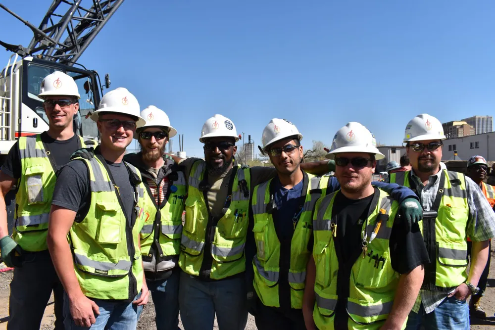Electricians in hard hats on a commercial job site