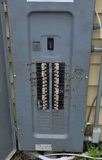Exterior breaker panel deadfront with the door open during an emergency service call