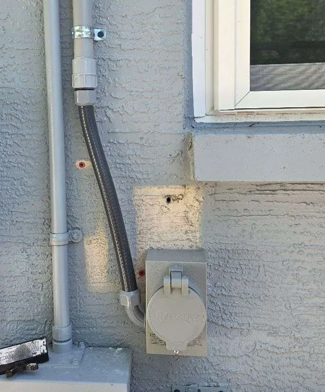 Generator power inlet box fed by liquid-tight conduit in Lutz