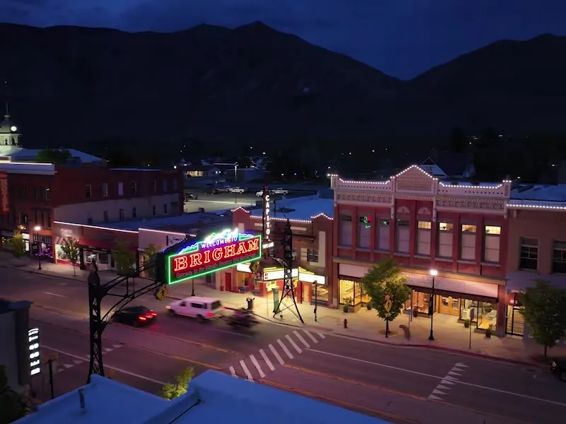 Downtown main street storefront buildings outlined with JellyFish Lighting accent points at dusk