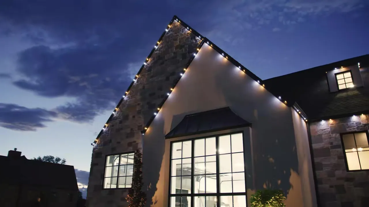 JellyFish Lighting in Gulfport, FL (Boca Ciega Bay Homes) Gable roofline outlined with warm white JellyFish Lighting points at dusk