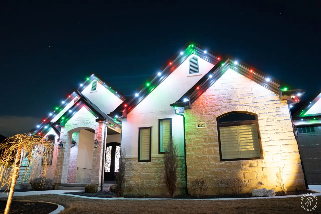 Stone gables with JellyFish permanent Christmas lights in holiday colors