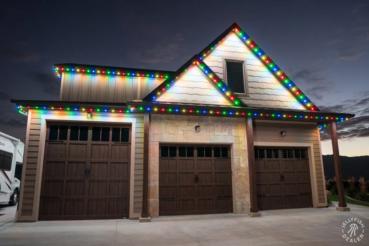 Three-car garage gable outlined in JellyFish permanent Christmas lights