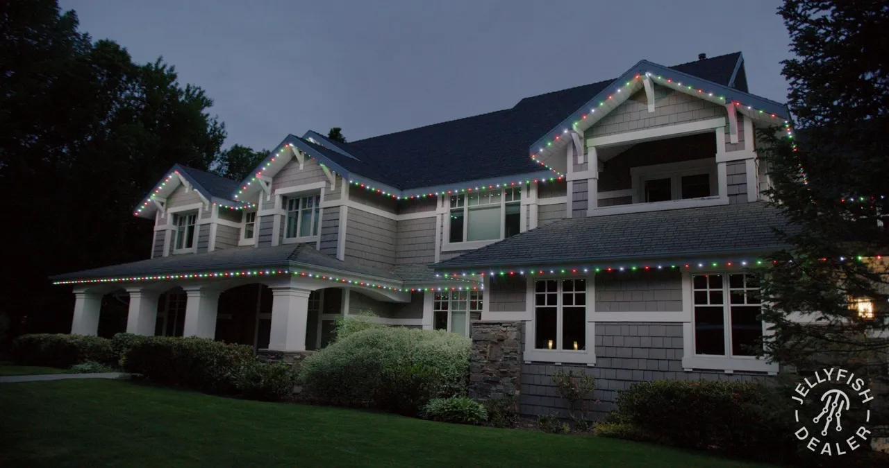 Permanent Christmas Lights in Pinellas County, FL Two-story home at night with JellyFish permanent Christmas lights running the full roofline
