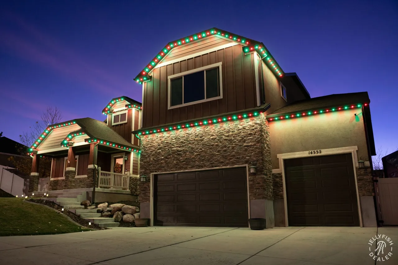 Permanent Christmas Lights in Clearwater Beach, FL Two-story home at dusk with warm accent JellyFish permanent lights under the soffits