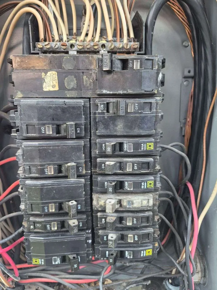 Before: old Clearwater panel with corroded breakers and tangled wiring