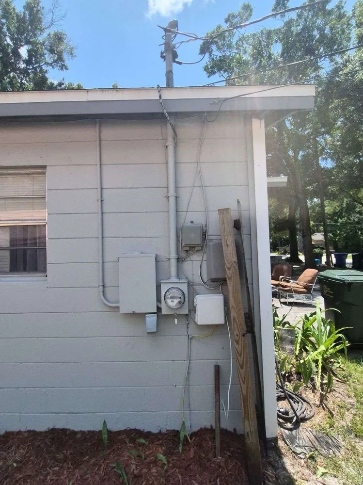 Electrical service upgrade in Clearwater, FL – before: the old exterior service, with a separate meter and a closed panel
