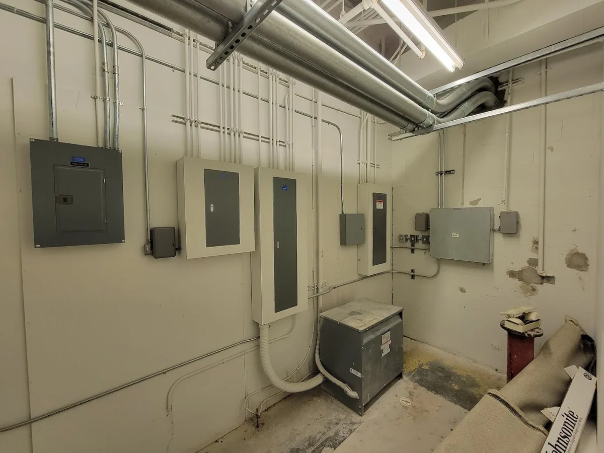 Commercial electrical room with panels, transformer and disconnects installed by Keywest Lights & Electric, Tampa Bay area