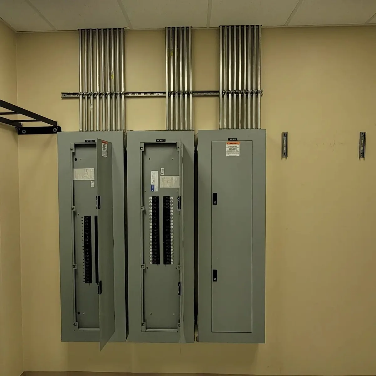 Home Commercial electrical work: three new panelboards with parallel EMT conduit runs, Tampa Bay area