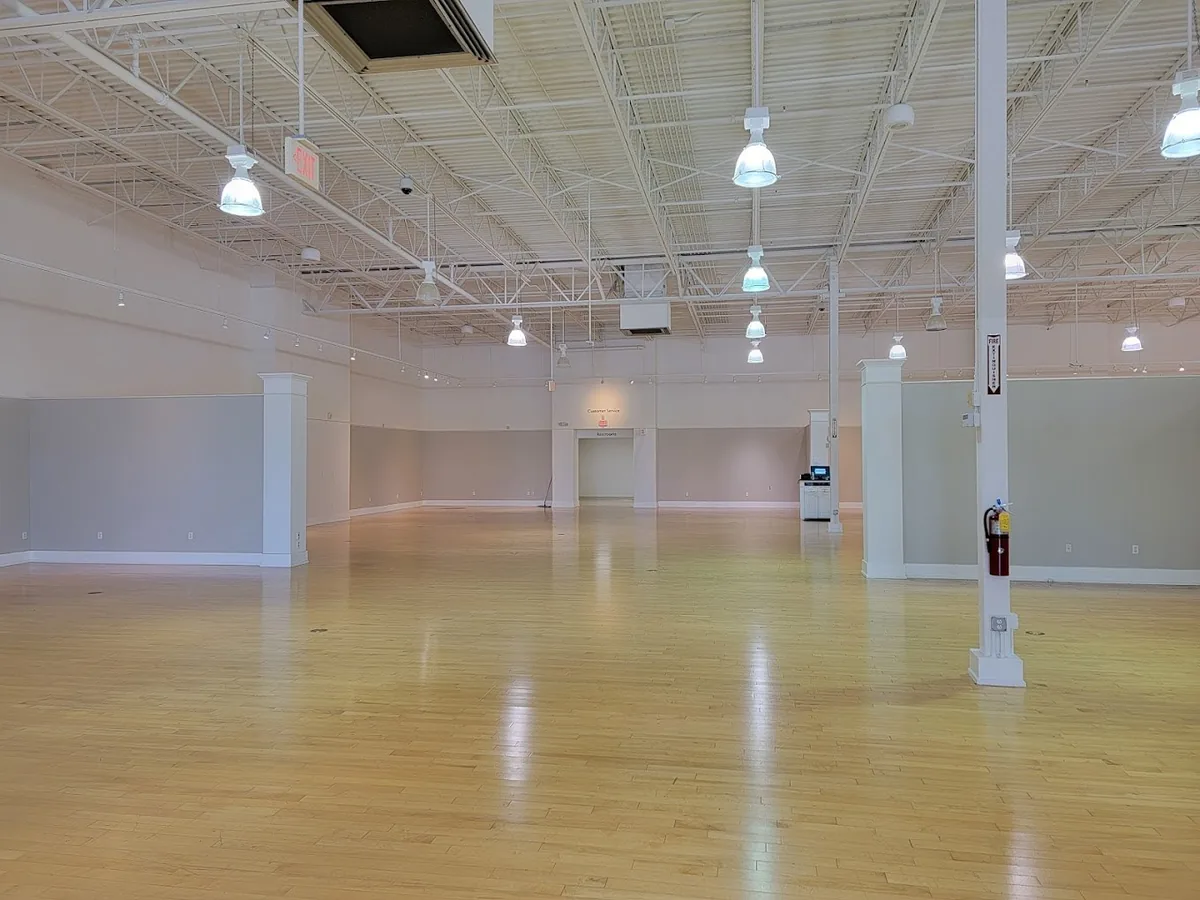 Commercial LED lighting in an event space with pendant fixtures over a wood floor, Tampa Bay area