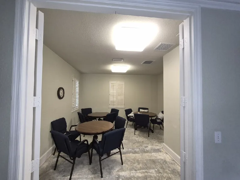 Commercial lighting remodel in St. Petersburg, FL – before: the meeting room with its old flush-mount ceiling fixtures