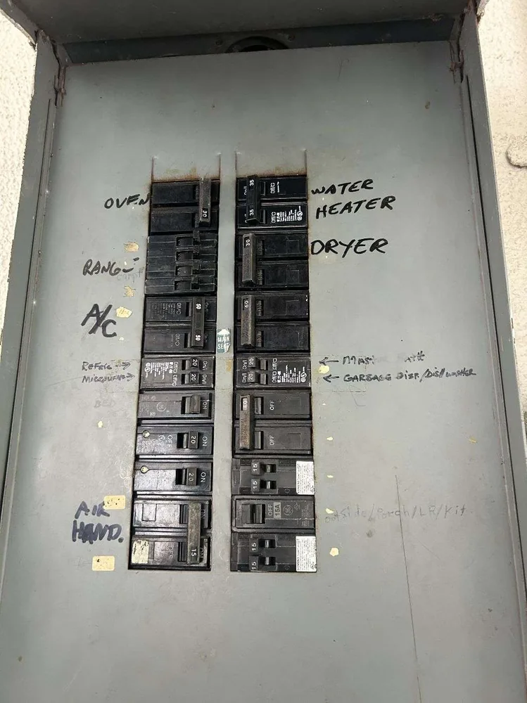 Panel replacement in St. Petersburg, FL – before the old breakers, labeled by hand in marker