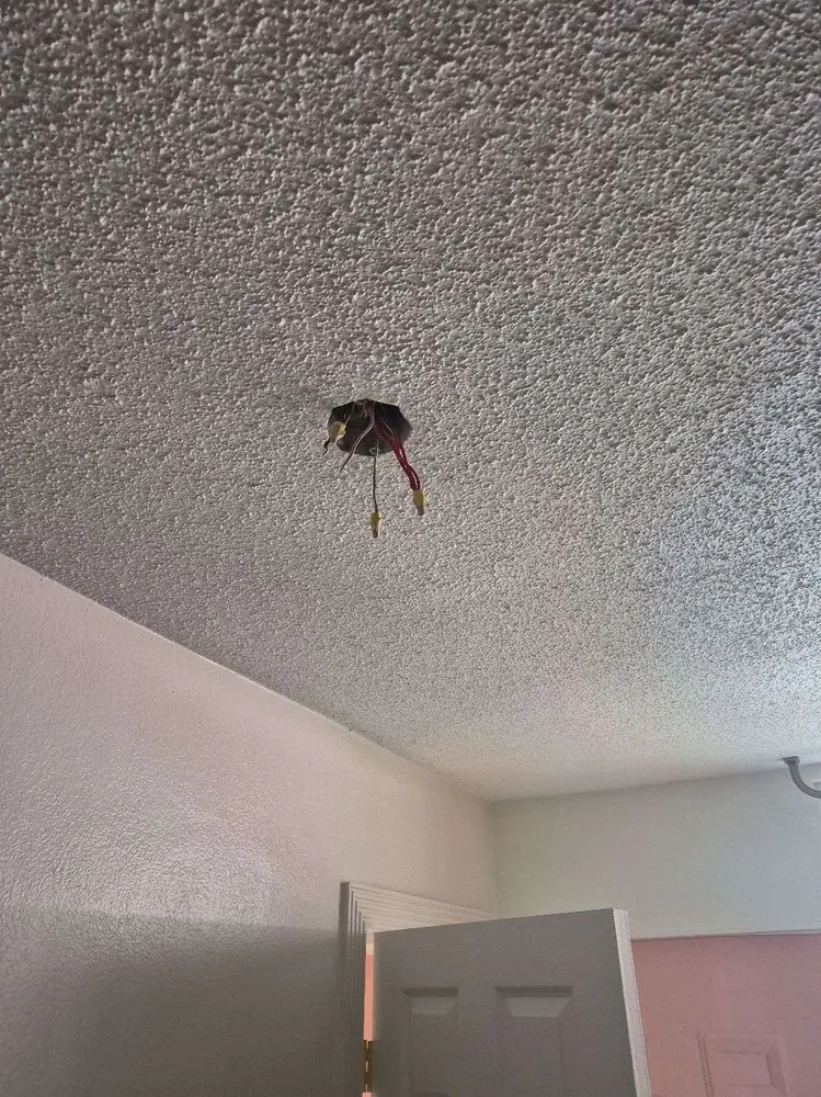 Commercial electrical repair in Clearwater Beach, FL – before open ceiling box with wires hanging and no fixture