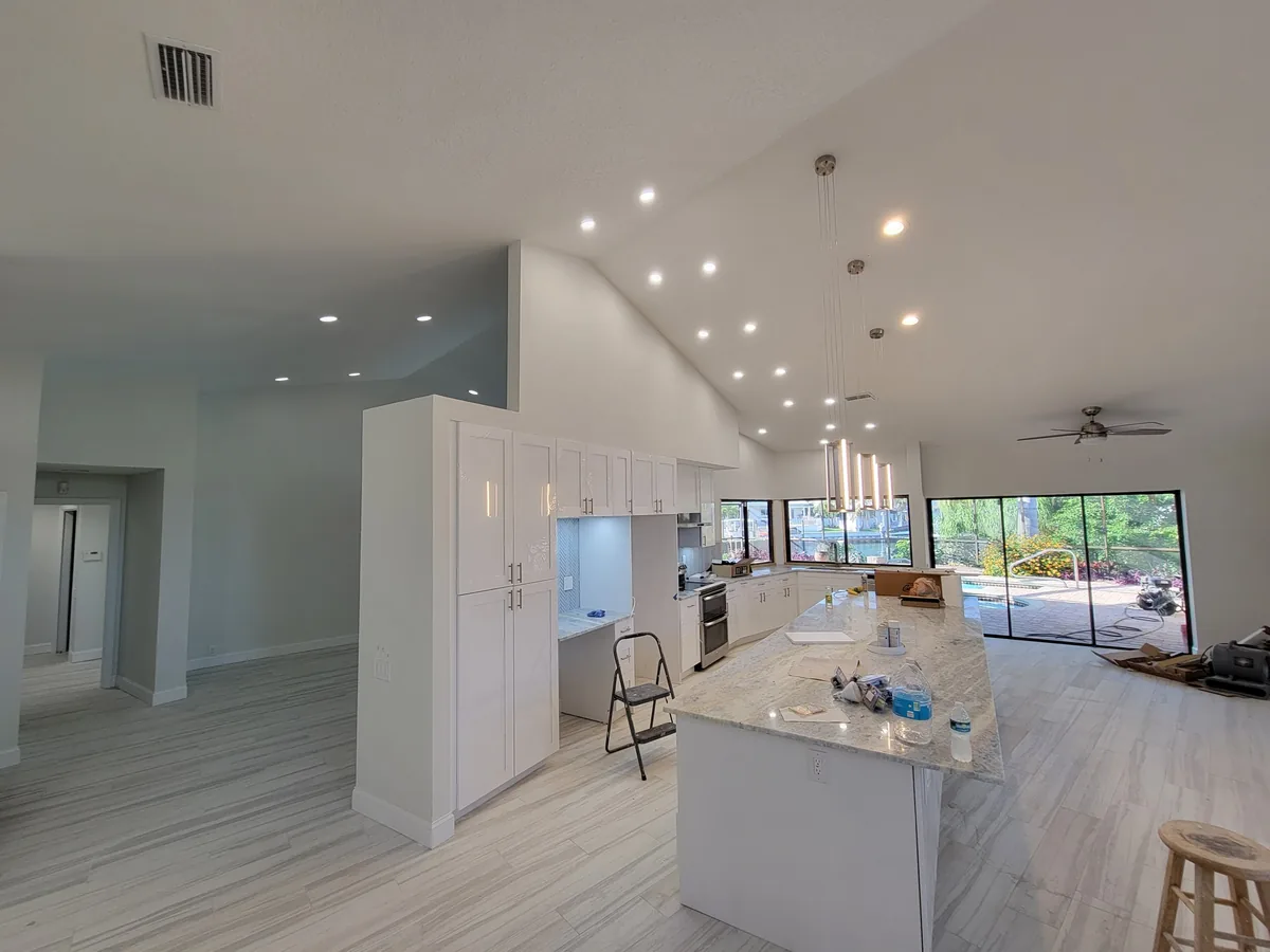 Ceiling Fan & Light Fixture Installation in St. Petersburg, FL Open-plan kitchen and living area in St. Petersburg, FL with recessed lighting and pendants installed by Keywest Lights & Electric