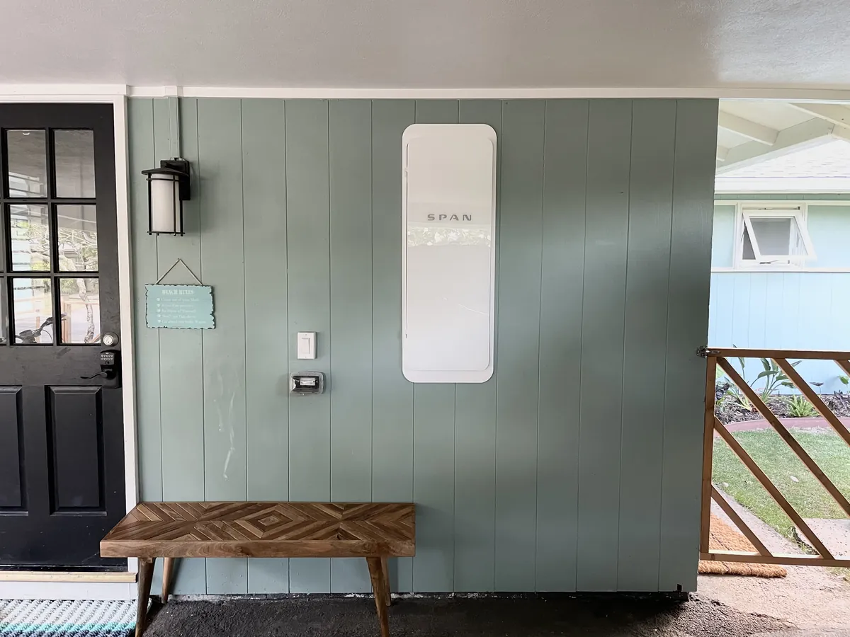 SPAN Smart Panel Installation in Belleair, FL SPAN Panel installed on the exterior wall of a home next to a covered porch