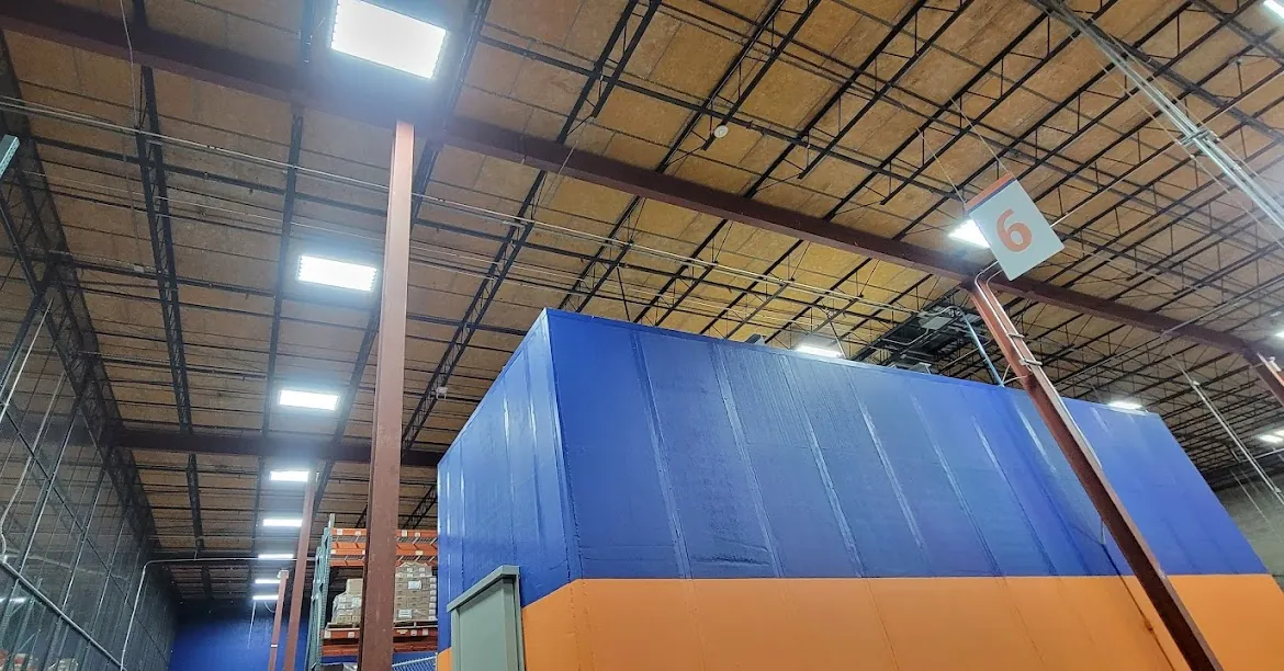 LED high-bay lighting under the roof deck of a commercial warehouse