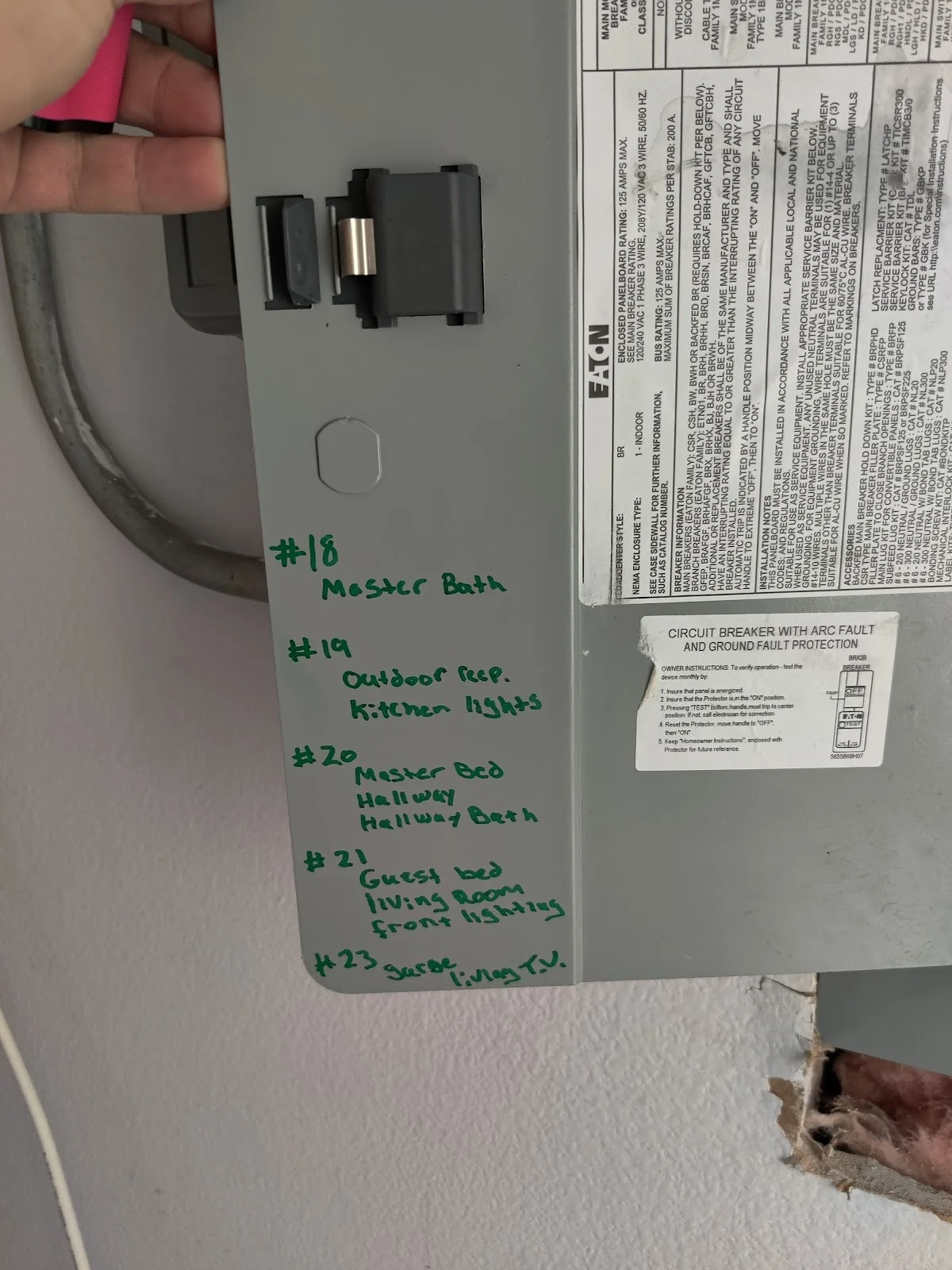 Panel cover with a handwritten circuit directory and AFCI label