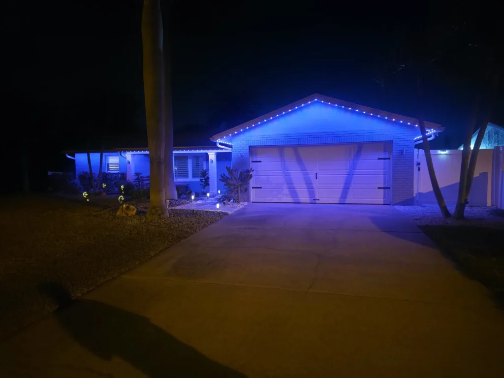Permanent Christmas Lights in Seminole and Pinellas: A Local Guide to Year-Round Roofline Lighting Permanent JellyFish roofline lights glowing blue along the garage and front eaves of a Pinellas County home at night.