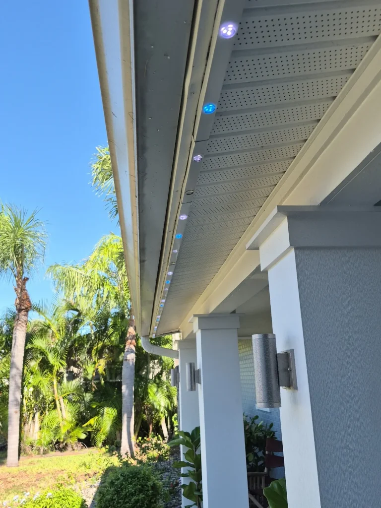 Permanent Christmas light track tucked under the roofline eave of a Tampa Bay home in daylight