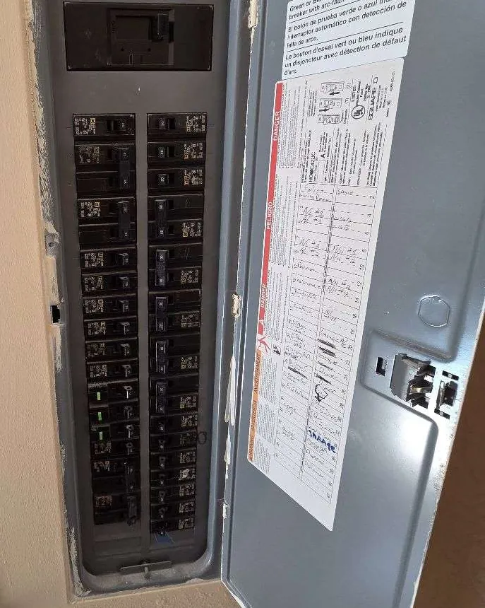 Residential breaker panel with AFCI breakers and a handwritten circuit directory