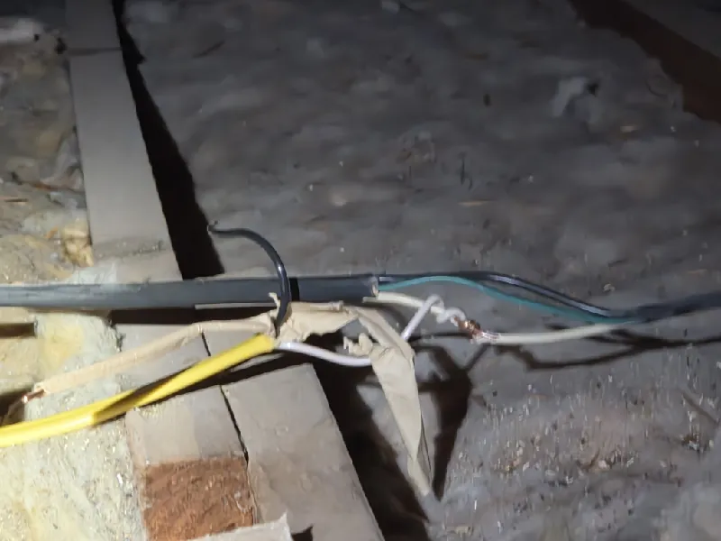 Taped cable splice found in an attic while tracing dead outlets in a Seminole, FL home
